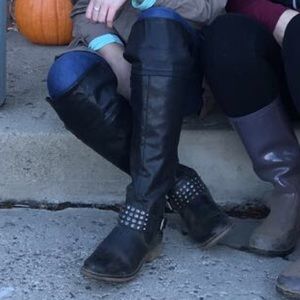 Tall black buckled boots